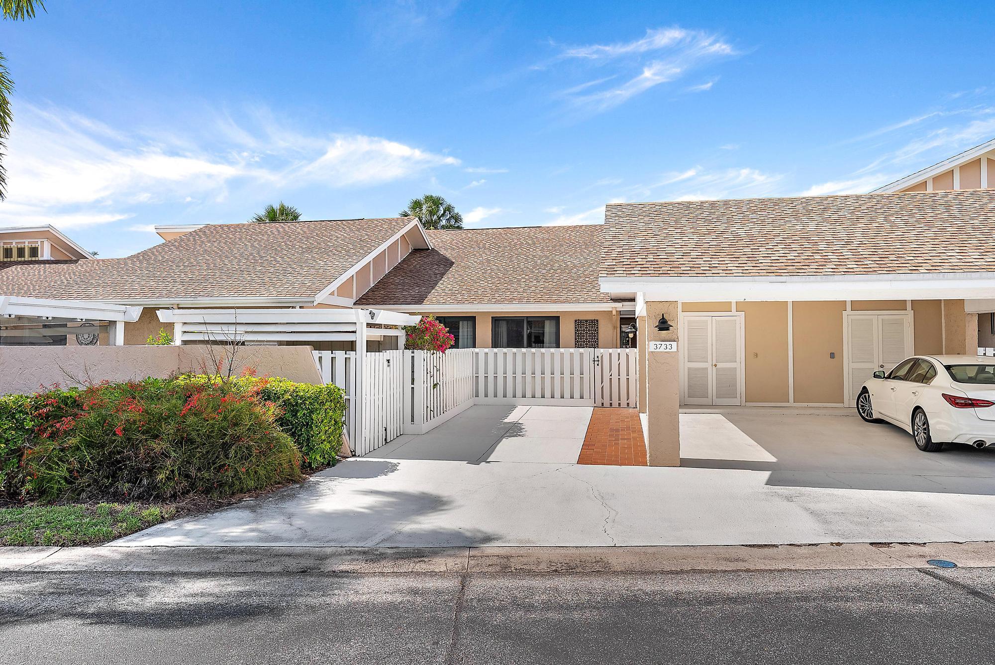 3733 Cape Pointe Circle Jupiter, FL 33477 - Photo 24 of 38 a front view of a house with a yard