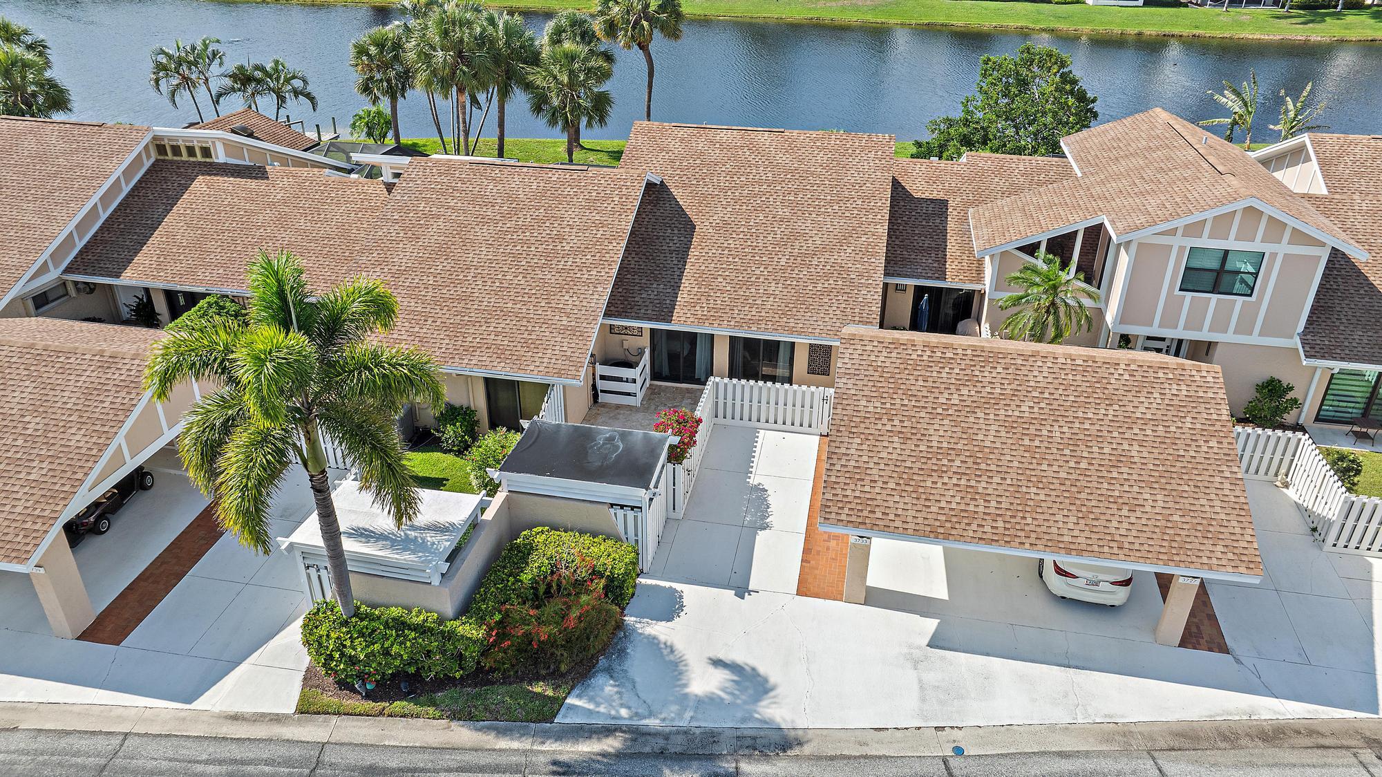 3733 Cape Pointe Circle Jupiter, FL 33477 - Photo 26 of 38 a aerial view of a house with garden space and sitting area