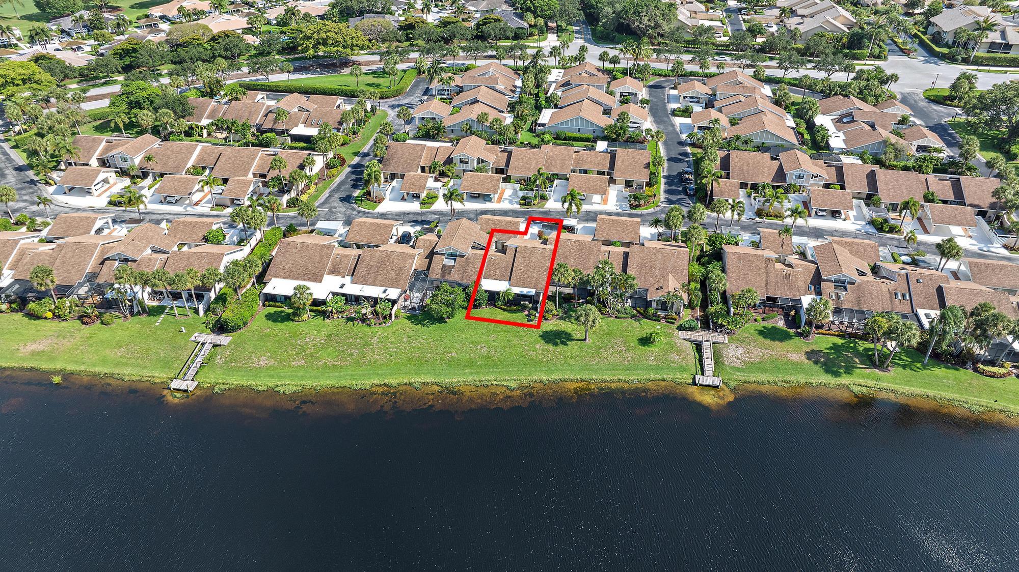 3733 Cape Pointe Circle Jupiter, FL 33477 - Photo 28 of 38 an aerial view of a house with a yard and lake view