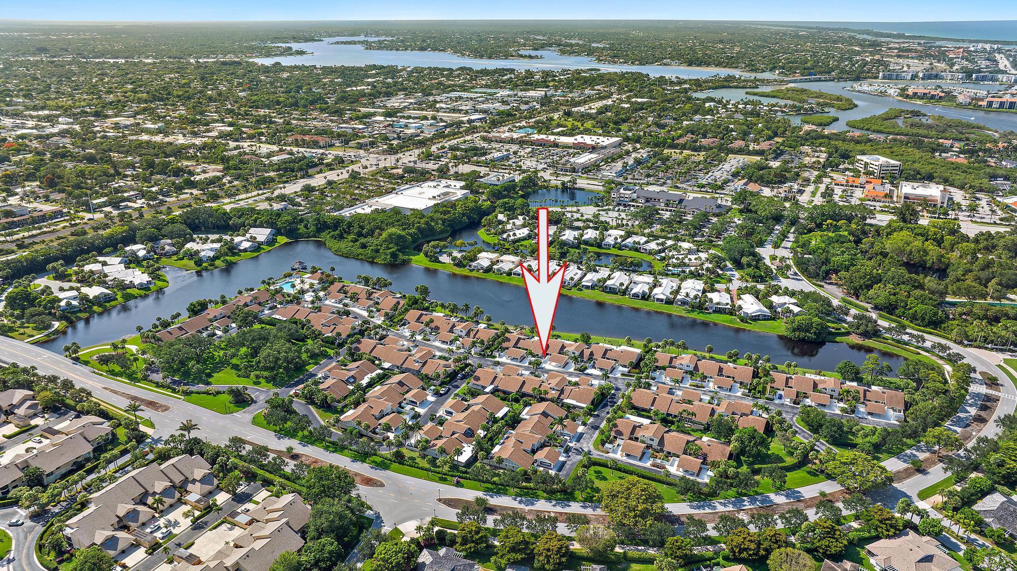 3733 Cape Pointe Circle Jupiter, FL 33477 - Photo 30 of 38 an aerial view of residential building and lake