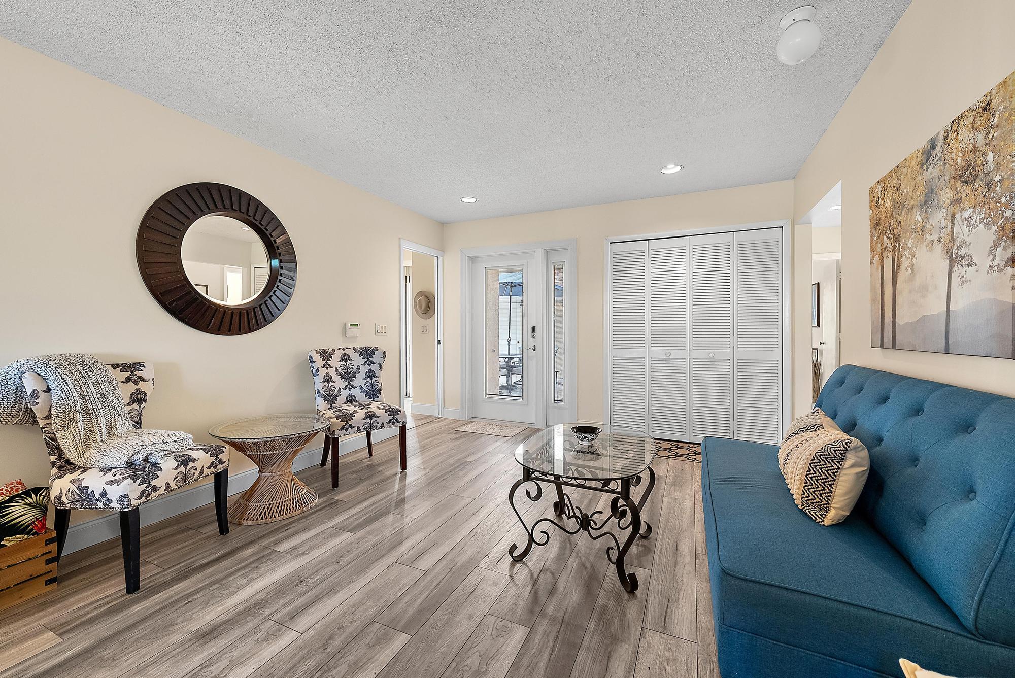 3733 Cape Pointe Circle Jupiter, FL 33477 - Photo 3 of 38 a living room with furniture and wooden floor