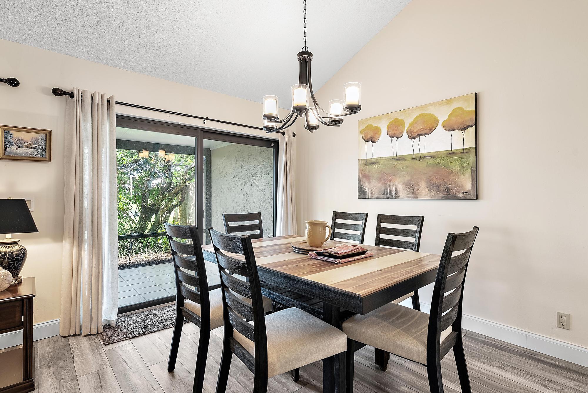 3733 Cape Pointe Circle Jupiter, FL 33477 - Photo 6 of 38 a view of a dining room with furniture window and wooden floor