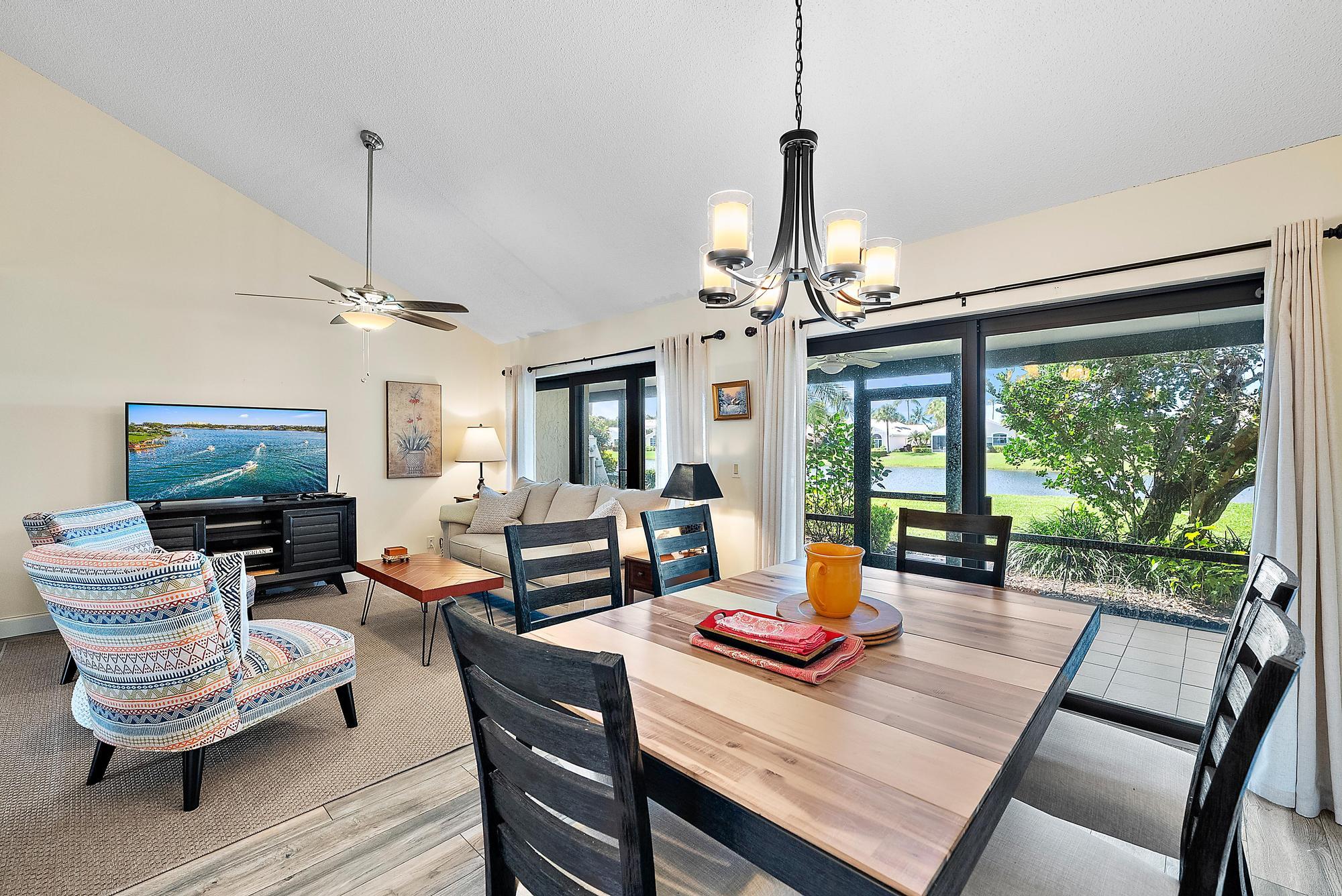 3733 Cape Pointe Circle Jupiter, FL 33477 - Photo 7 of 38 a living room with furniture a fireplace and a flat screen tv