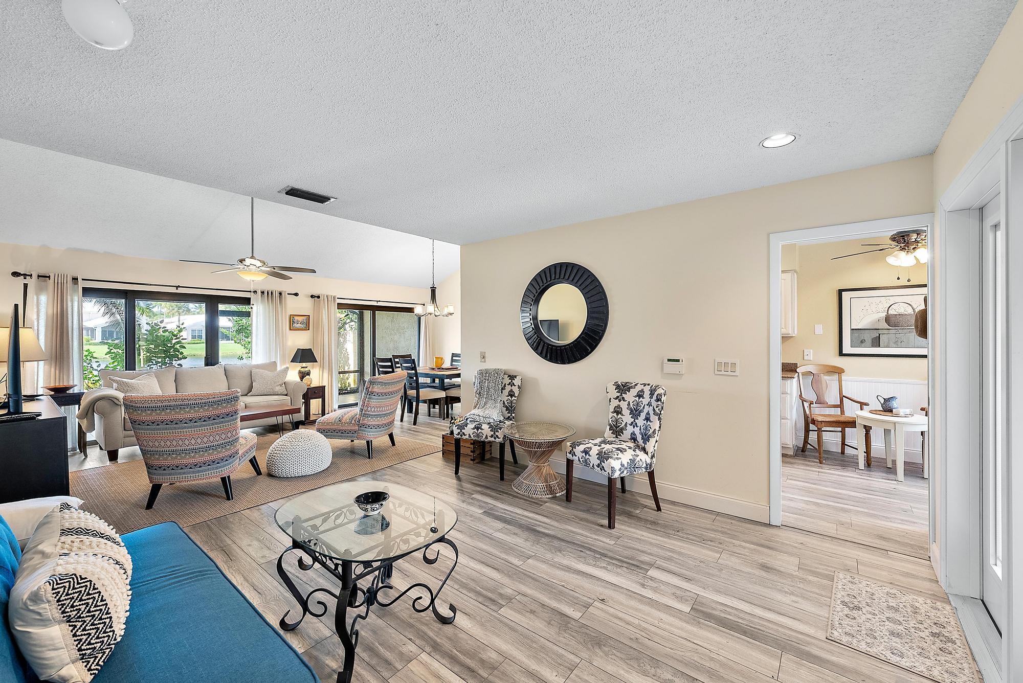 3733 Cape Pointe Circle Jupiter, FL 33477 - Photo 9 of 38 a living room with lots of furniture and a large window