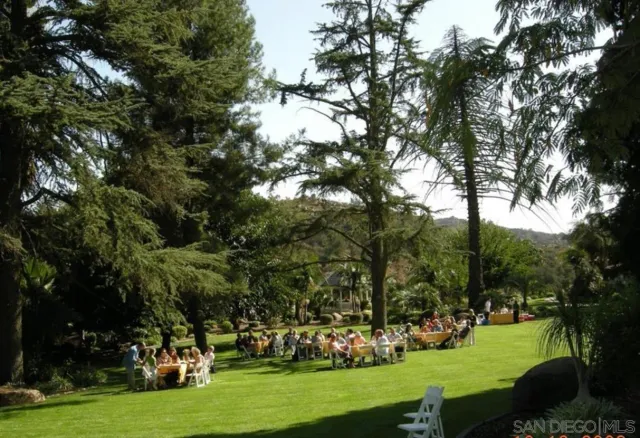a view of a house with a backyard and garage