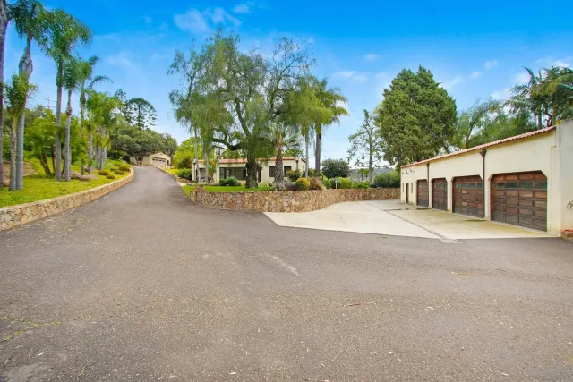 a big room with yard and car parked in front of it