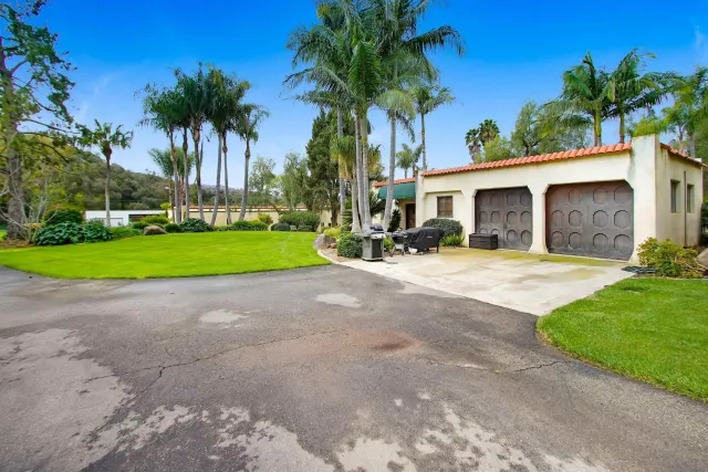 a view of a house with a yard and a car parked