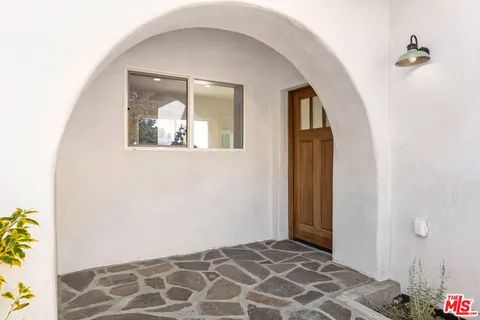 a view of an entryway with wooden floor