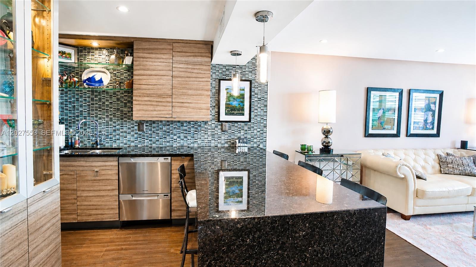 100 Lincoln Road, Unit 533 Miami Beach, FL 33139 - Photo 6 of 26 a kitchen with stainless steel appliances granite countertop a sink and a wooden floor
