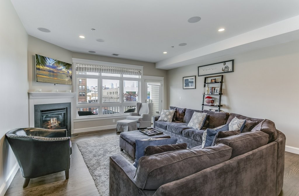 350 West 2nd Street, Unit 2 Boston, MA 02127 - Photo 1 of 12 a living room with furniture and a fireplace