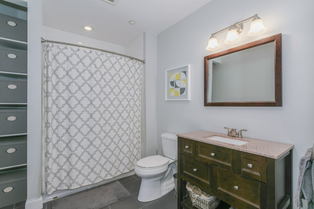 350 West 2nd Street, Unit 2 Boston, MA 02127 - Photo 11 of 12 a bathroom with a toilet sink vanity and mirror