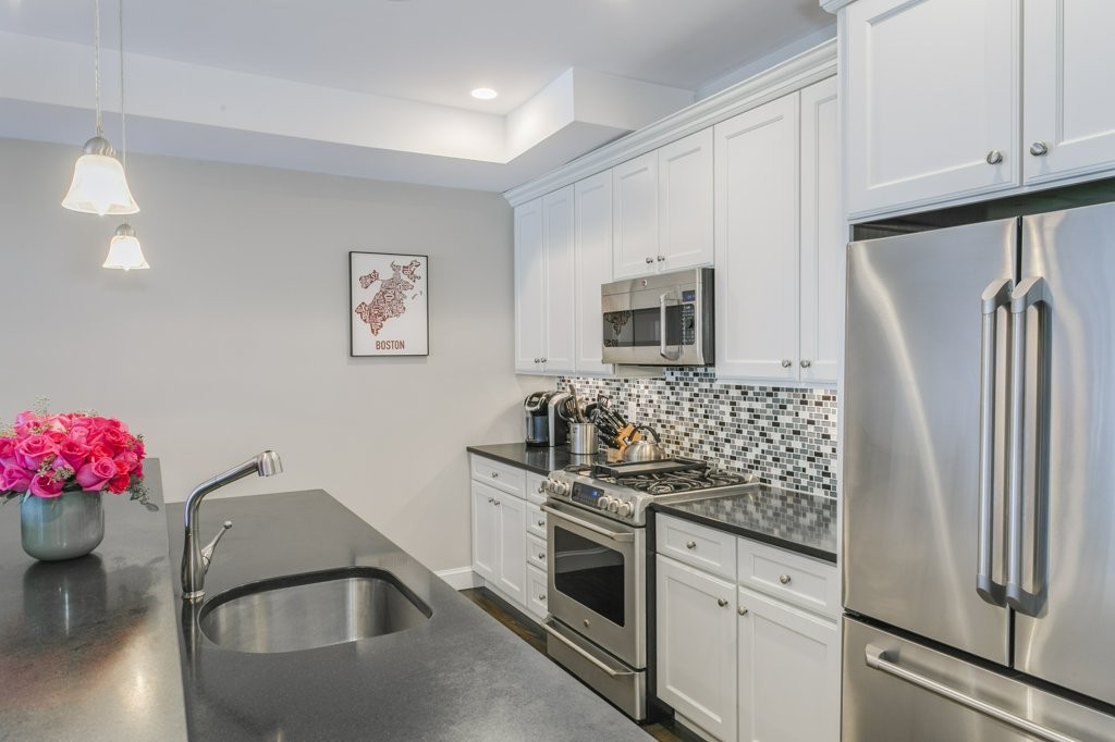 350 West 2nd Street, Unit 2 Boston, MA 02127 - Photo 6 of 12 a kitchen with granite countertop a sink stove and refrigerator