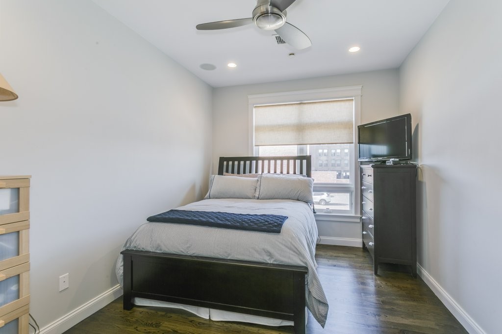 350 West 2nd Street, Unit 2 Boston, MA 02127 - Photo 10 of 12 a bedroom with a bed and a television
