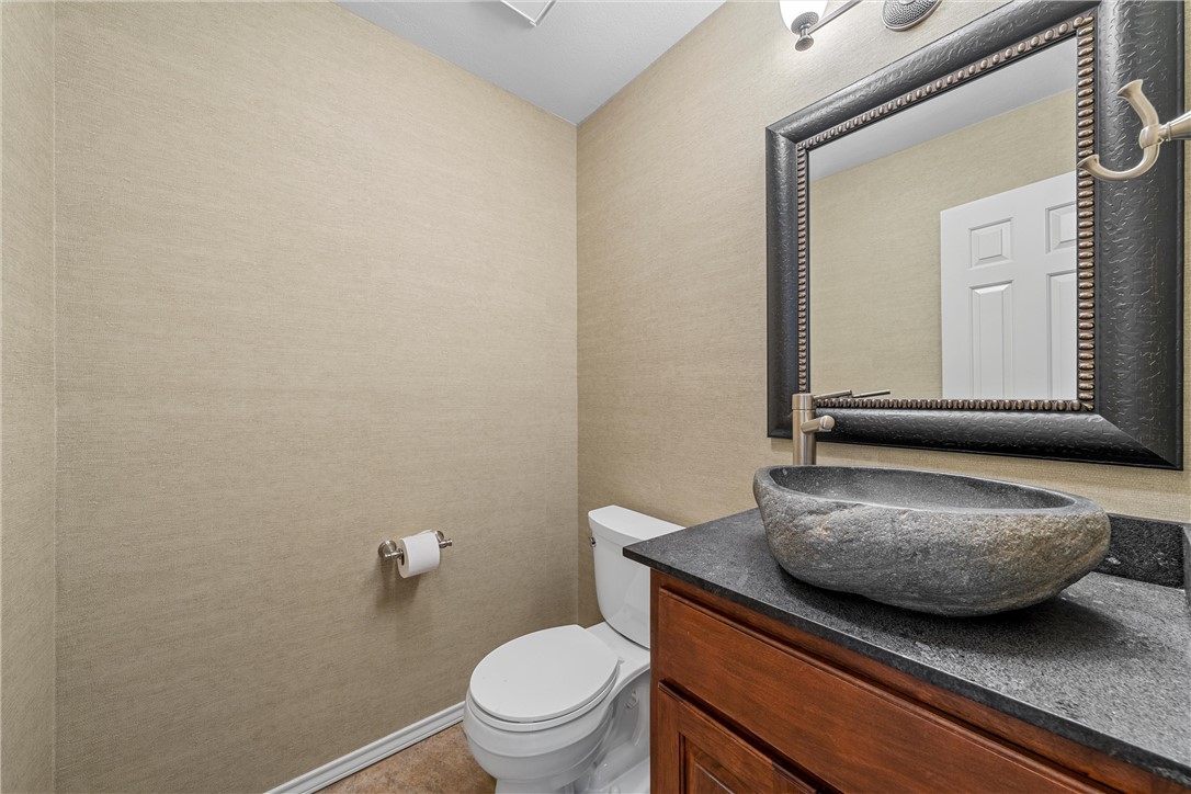 125 Pleasant Grove Lane Waco, TX 76712 - Photo 13 of 25 a bathroom with a granite countertop toilet and mirror