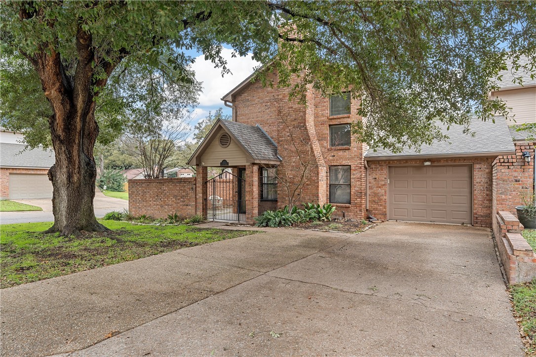125 Pleasant Grove Lane Waco, TX 76712 - Photo 2 of 25 a front view of a house with a yard and garage