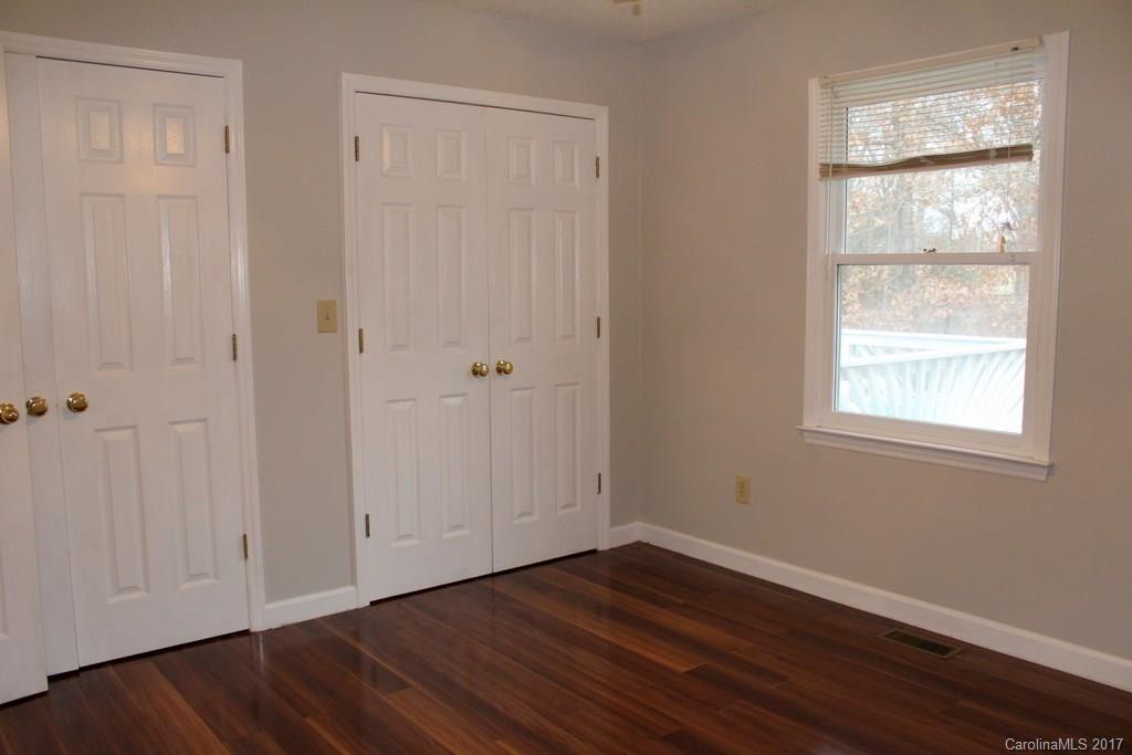 1417 Shiloh Ranch Road Lancaster, SC 29720 - Photo 16 of 23 an empty room with wooden floor and windows