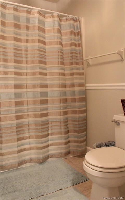 1417 Shiloh Ranch Road Lancaster, SC 29720 - Photo 18 of 23 a bathroom with a toilet and a shower curtain