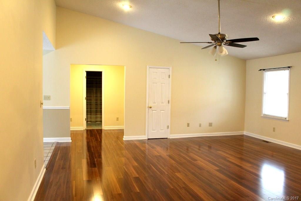 1417 Shiloh Ranch Road Lancaster, SC 29720 - Photo 6 of 23 an empty room with wooden floor a ceiling fan and windows