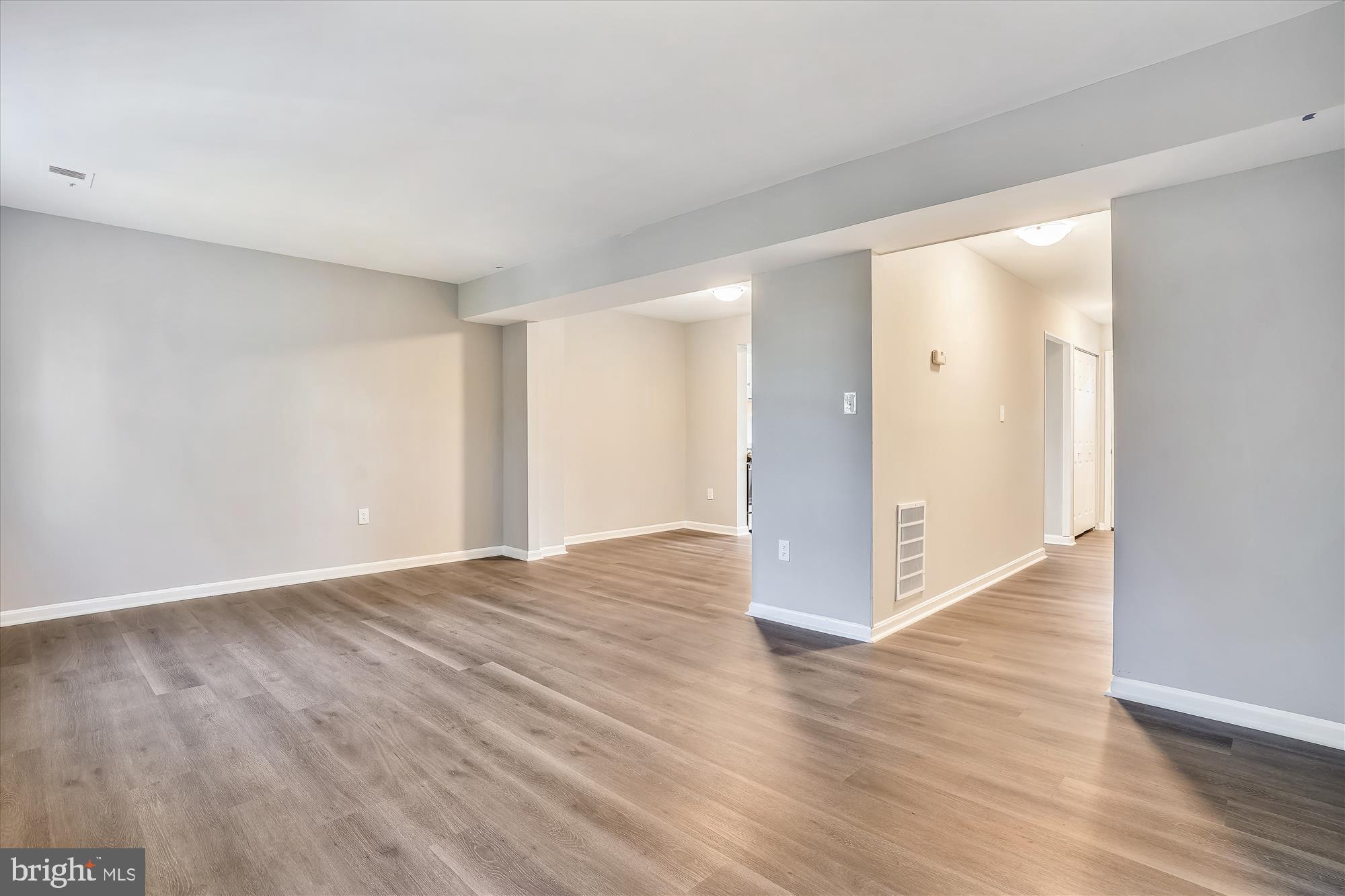 9202 Sprucewood Road Burke, VA 22015 - Photo 11 of 21 a view of an empty room with wooden floor and a window