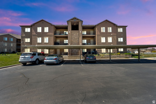 8215 Clear Rock Road, Unit 12 Eagle Mountain, UT 84005 - Photo 30 of 38 Multi-story building featuring a brown exterior with stone accents and multiple private balconies