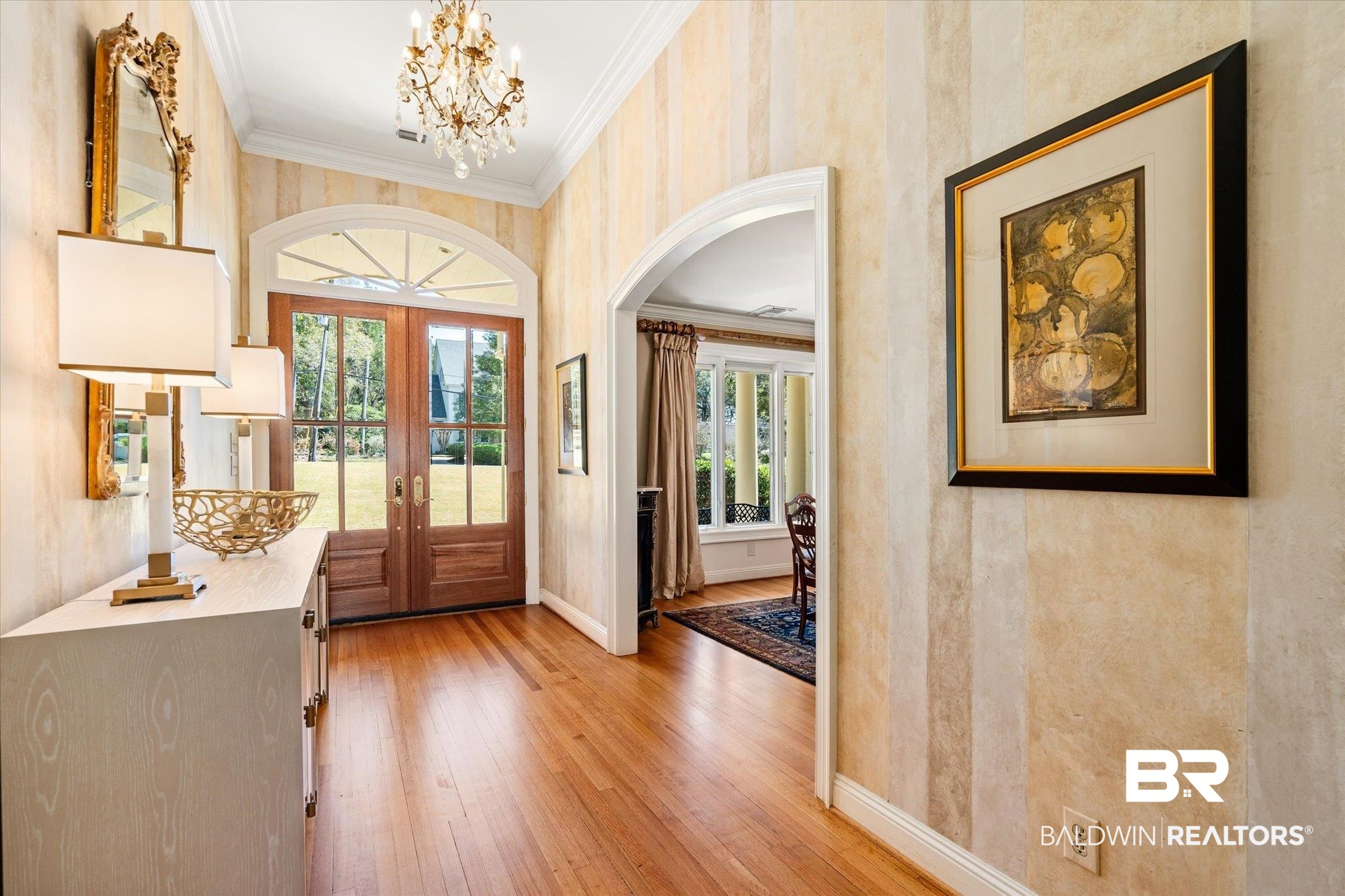 4 Kingsway Mobile, AL 36608 - Photo 3 of 44 Entryway with crown molding, baseboards, hardwood / wood-style floors, french doors, and an inviting chandelier