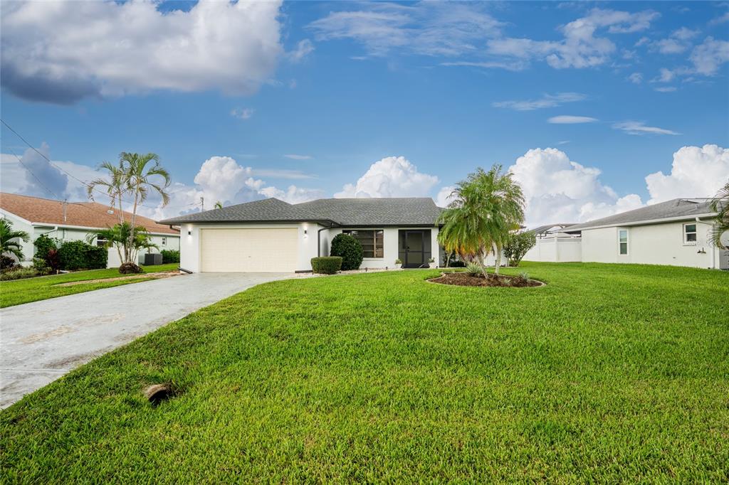 a front view of a house with a yard and garage