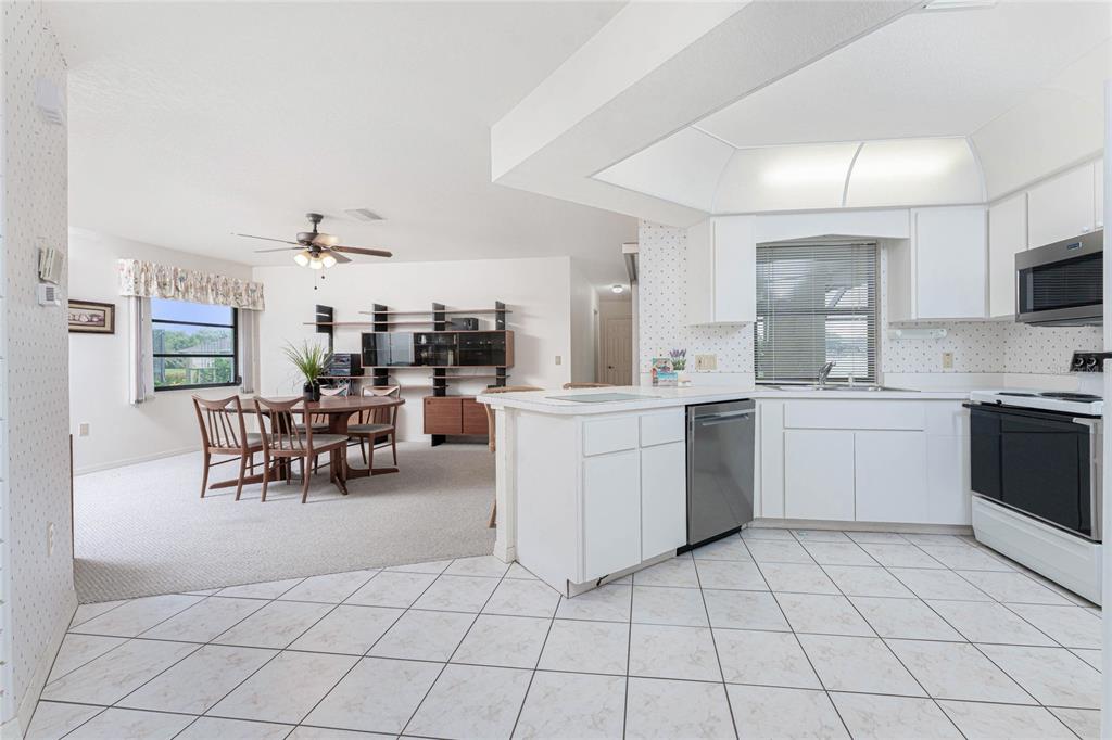 21 Bunker Lane Rotonda West, FL 33947 - Photo 11 of 51 a kitchen with cabinets and chairs
