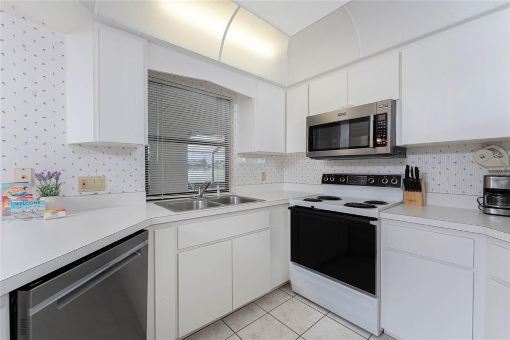 21 Bunker Lane Rotonda West, FL 33947 - Photo 13 of 51 a kitchen with a sink stove and microwave