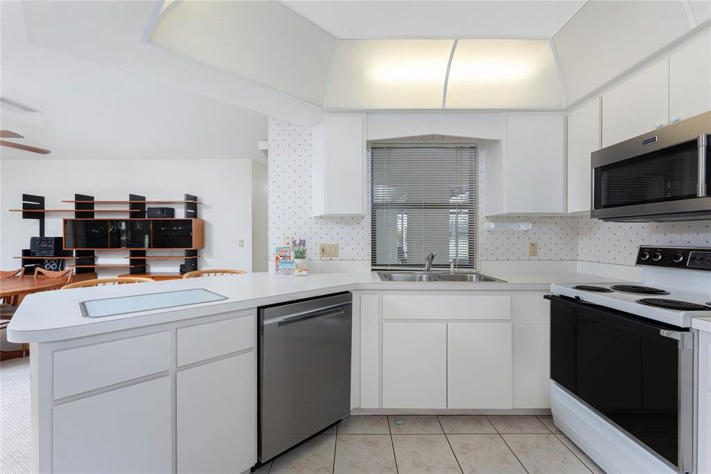 21 Bunker Lane Rotonda West, FL 33947 - Photo 14 of 51 a kitchen with a sink stove and microwave
