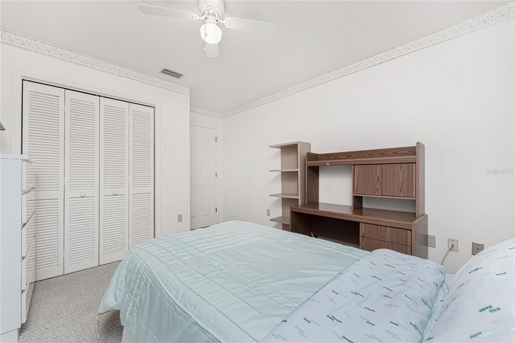 21 Bunker Lane Rotonda West, FL 33947 - Photo 23 of 51 a bedroom with a bed and cabinets