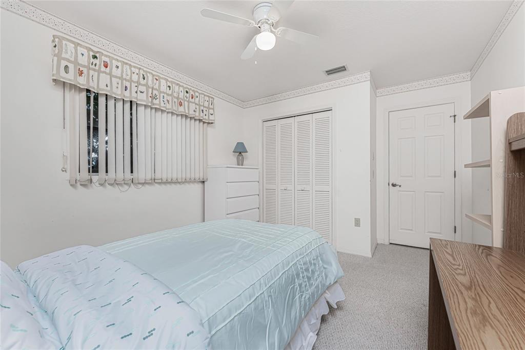 21 Bunker Lane Rotonda West, FL 33947 - Photo 24 of 51 a bedroom with a bed and a chandelier