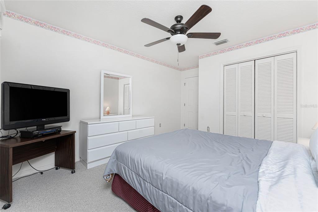 21 Bunker Lane Rotonda West, FL 33947 - Photo 29 of 51 a bedroom with a bed and a flat screen tv