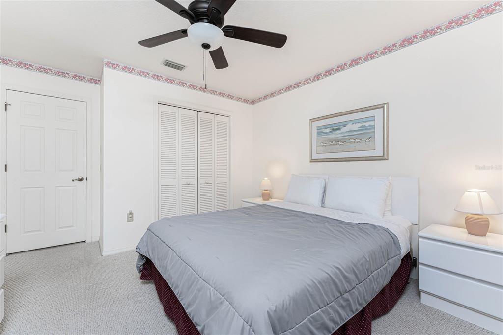21 Bunker Lane Rotonda West, FL 33947 - Photo 30 of 51 a bedroom with a bed and a chandelier