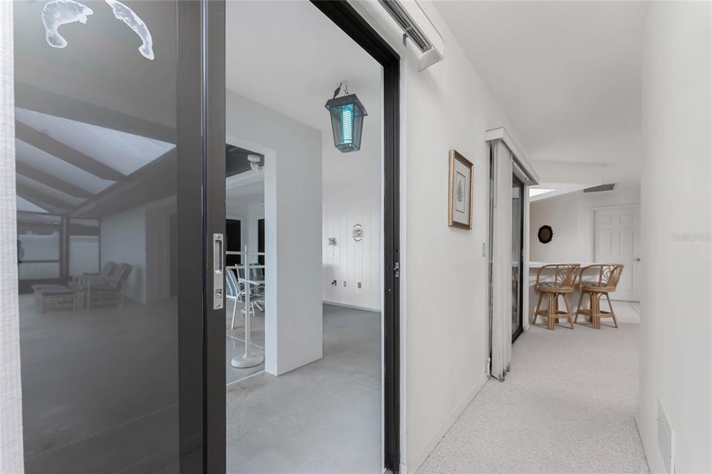 21 Bunker Lane Rotonda West, FL 33947 - Photo 31 of 51 a view of a hallway with wooden floor and dining room