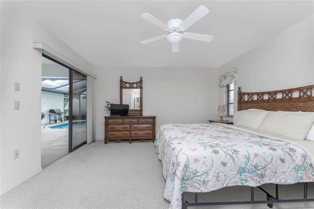 21 Bunker Lane Rotonda West, FL 33947 - Photo 33 of 51 a bedroom with a bed and a chandelier