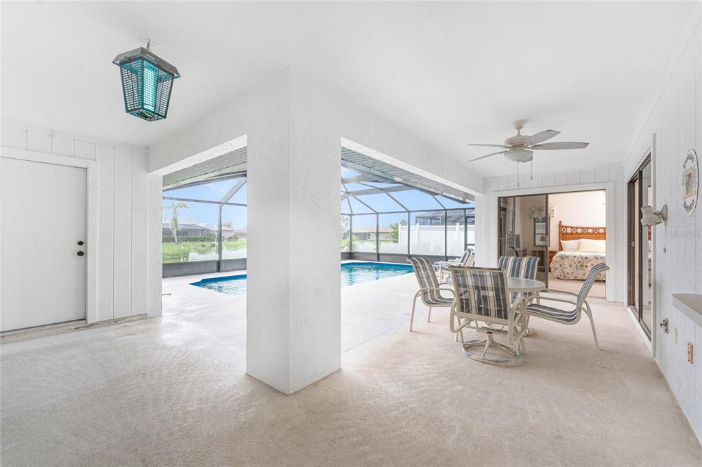 21 Bunker Lane Rotonda West, FL 33947 - Photo 39 of 51 a dining room with furniture and a floor to ceiling window