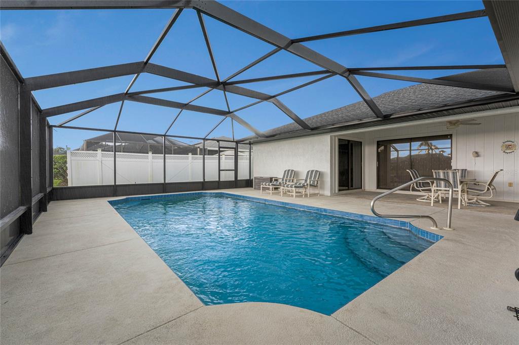 21 Bunker Lane Rotonda West, FL 33947 - Photo 45 of 51 a view of a patio with a table and chairs under an umbrella