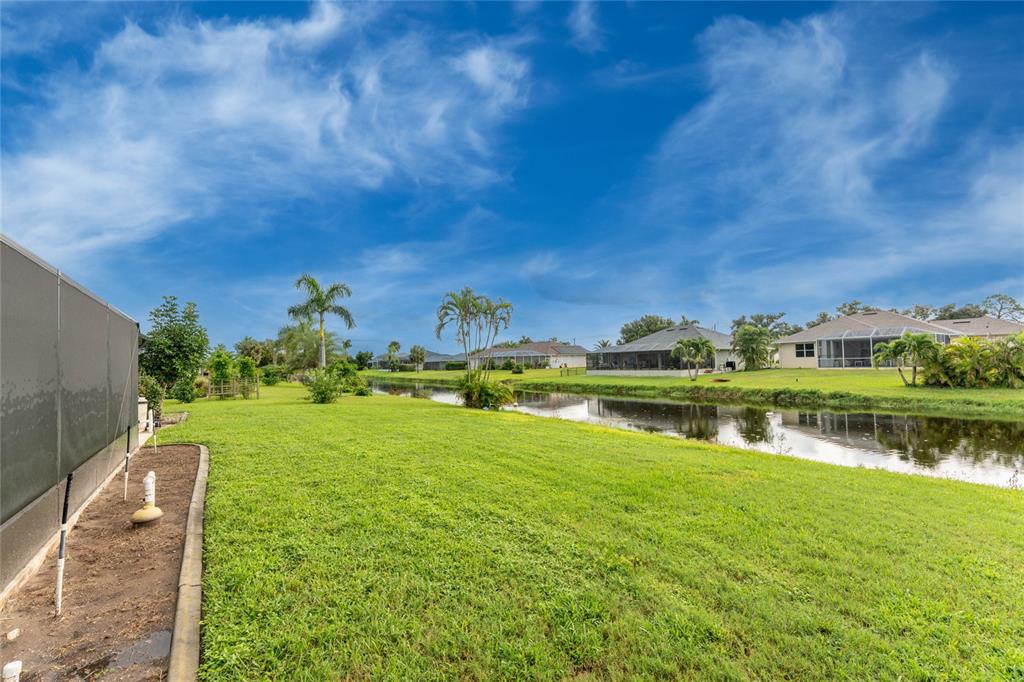21 Bunker Lane Rotonda West, FL 33947 - Photo 46 of 51 a view of a lake with houses in the background