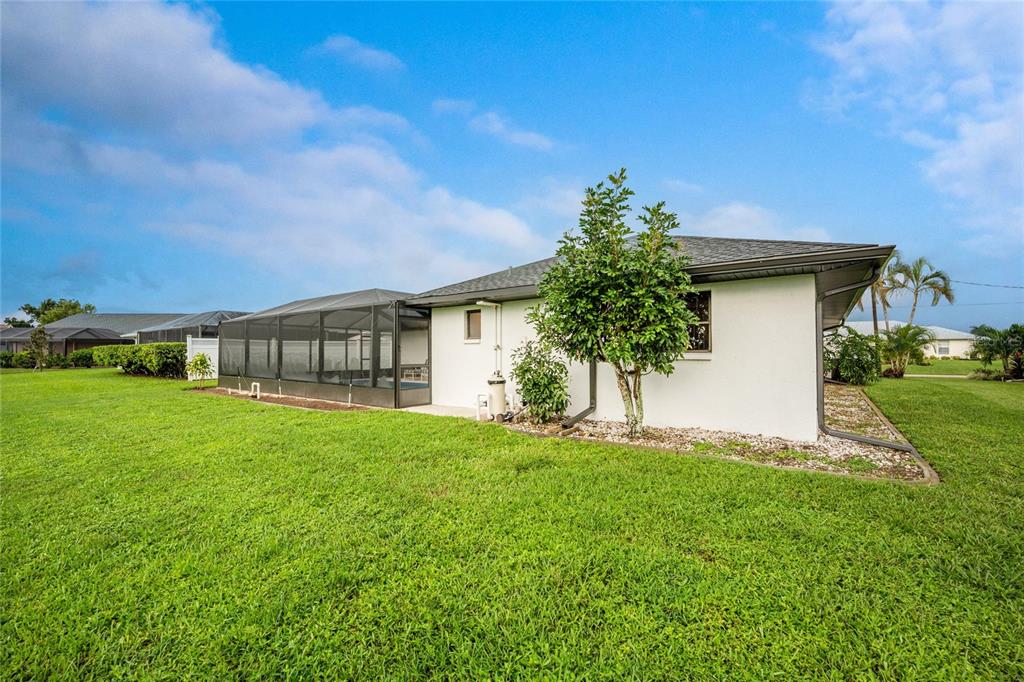 21 Bunker Lane Rotonda West, FL 33947 - Photo 48 of 51 a front view of a house with a garden