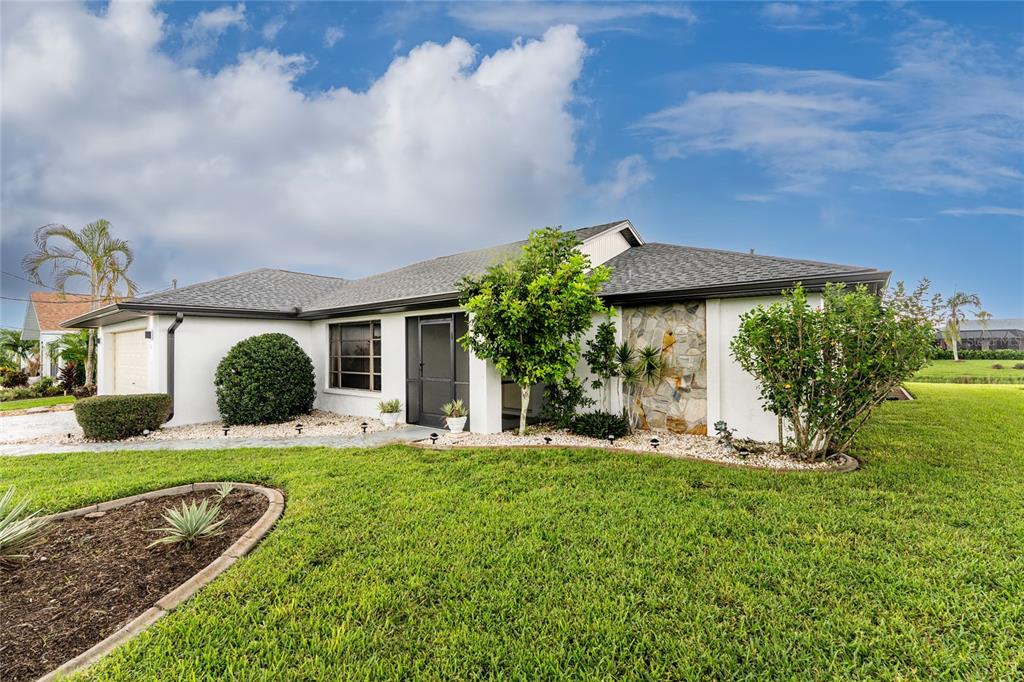 21 Bunker Lane Rotonda West, FL 33947 - Photo 51 of 51 a front view of a house with garden