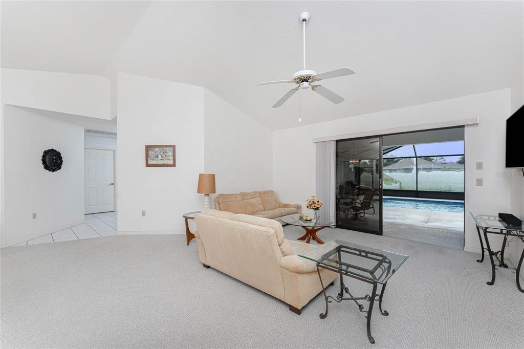 21 Bunker Lane Rotonda West, FL 33947 - Photo 8 of 51 a living room with furniture and a floor to ceiling window