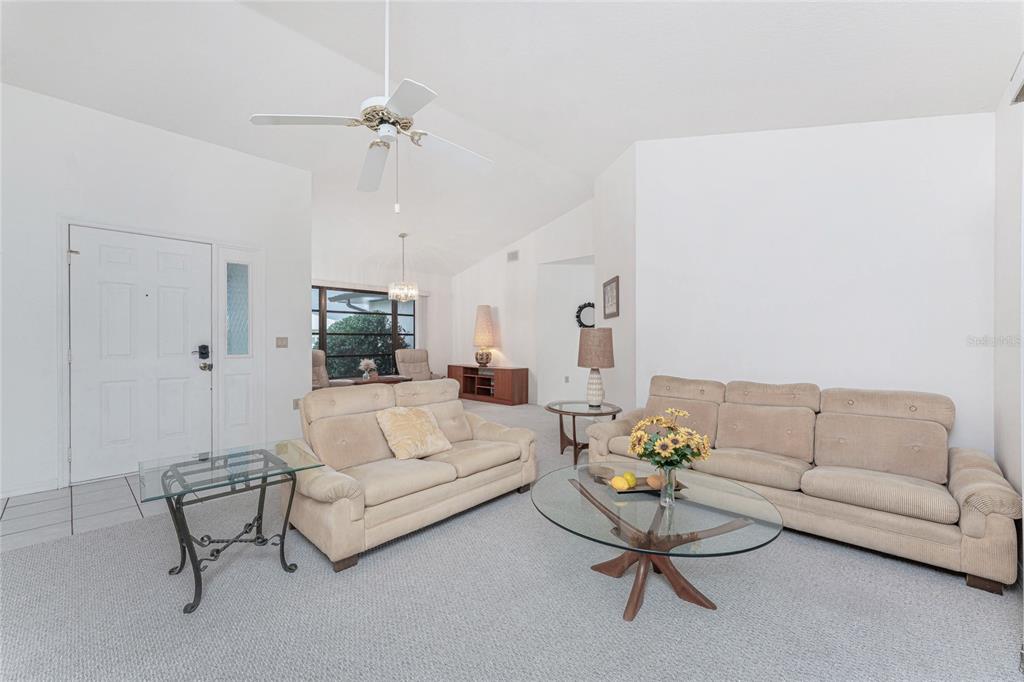 21 Bunker Lane Rotonda West, FL 33947 - Photo 10 of 51 a living room with furniture and a chandelier