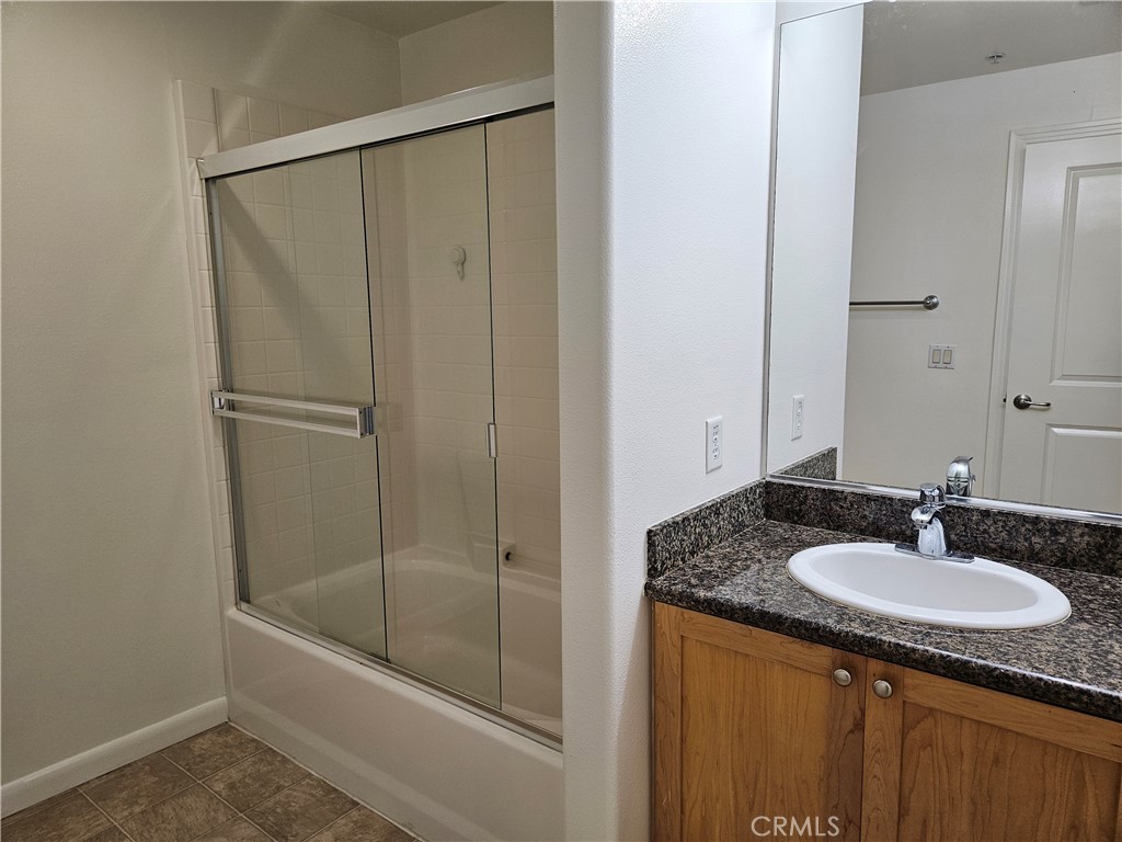 100 South Alameda Street, Unit 348 Los Angeles, CA 90012 - Photo 8 of 15 a bathroom with a granite countertop sink and a mirror