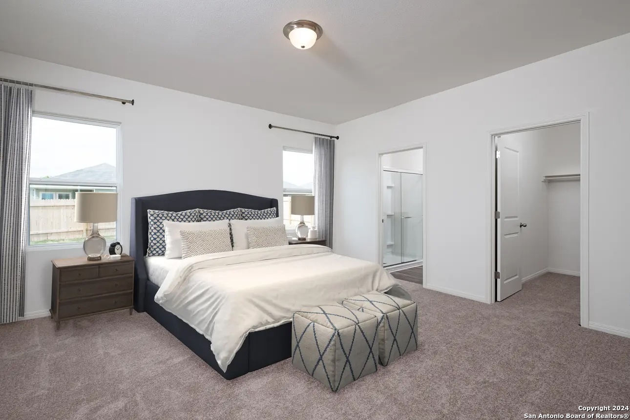 10507 Lesser Snow Adkins, TX 78101 - Photo 14 of 18 a bedroom with a bed and a couch