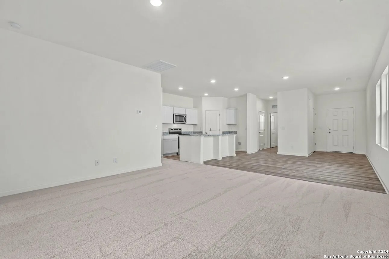 10507 Lesser Snow Adkins, TX 78101 - Photo 9 of 18 a view of kitchen with refrigerator and kitchen island