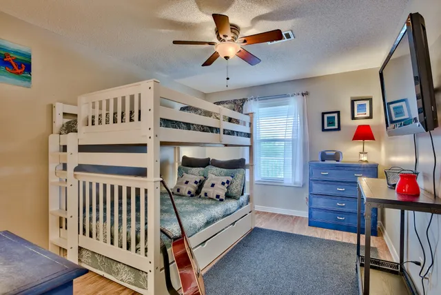 a bedroom with furniture and a baby crib