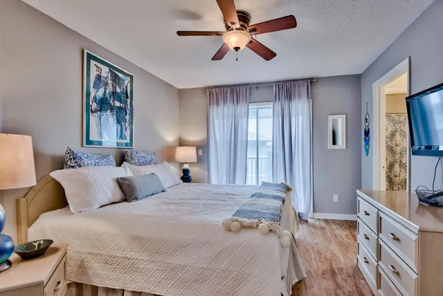 a bedroom with a large bed and a flat screen tv