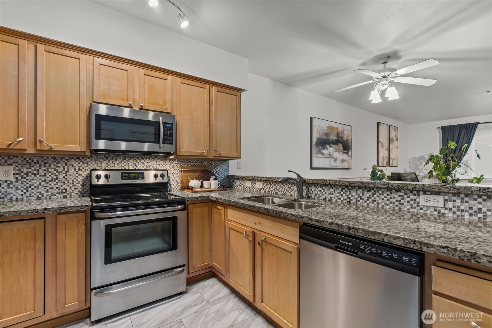 440 Maple Avenue Southwest, Unit A106 Renton, WA 98057 - Photo 15 of 39 a kitchen with stainless steel appliances granite countertop a stove microwave and cabinets