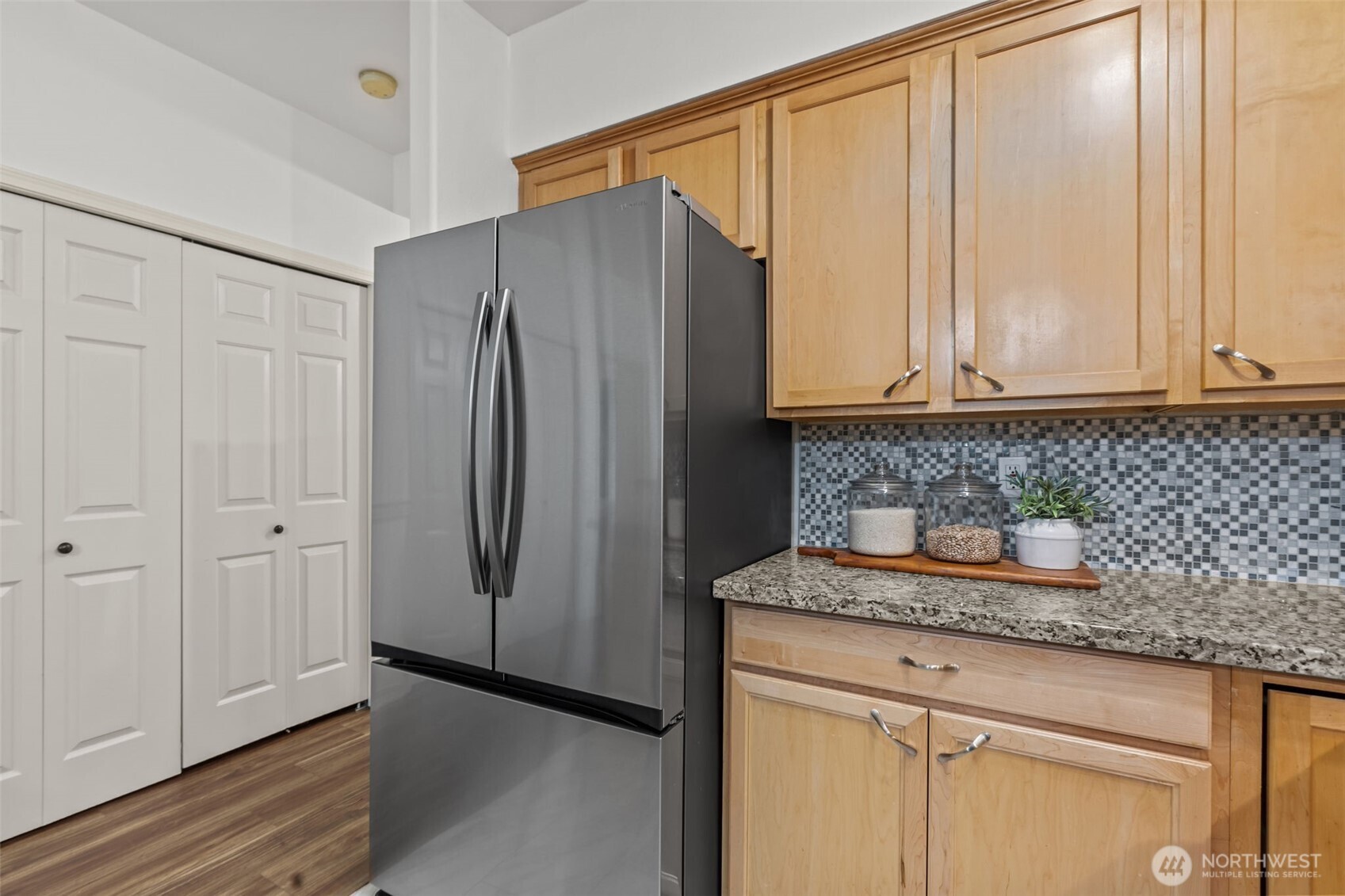 440 Maple Avenue Southwest, Unit A106 Renton, WA 98057 - Photo 17 of 39 a kitchen with a refrigerator and cabinets