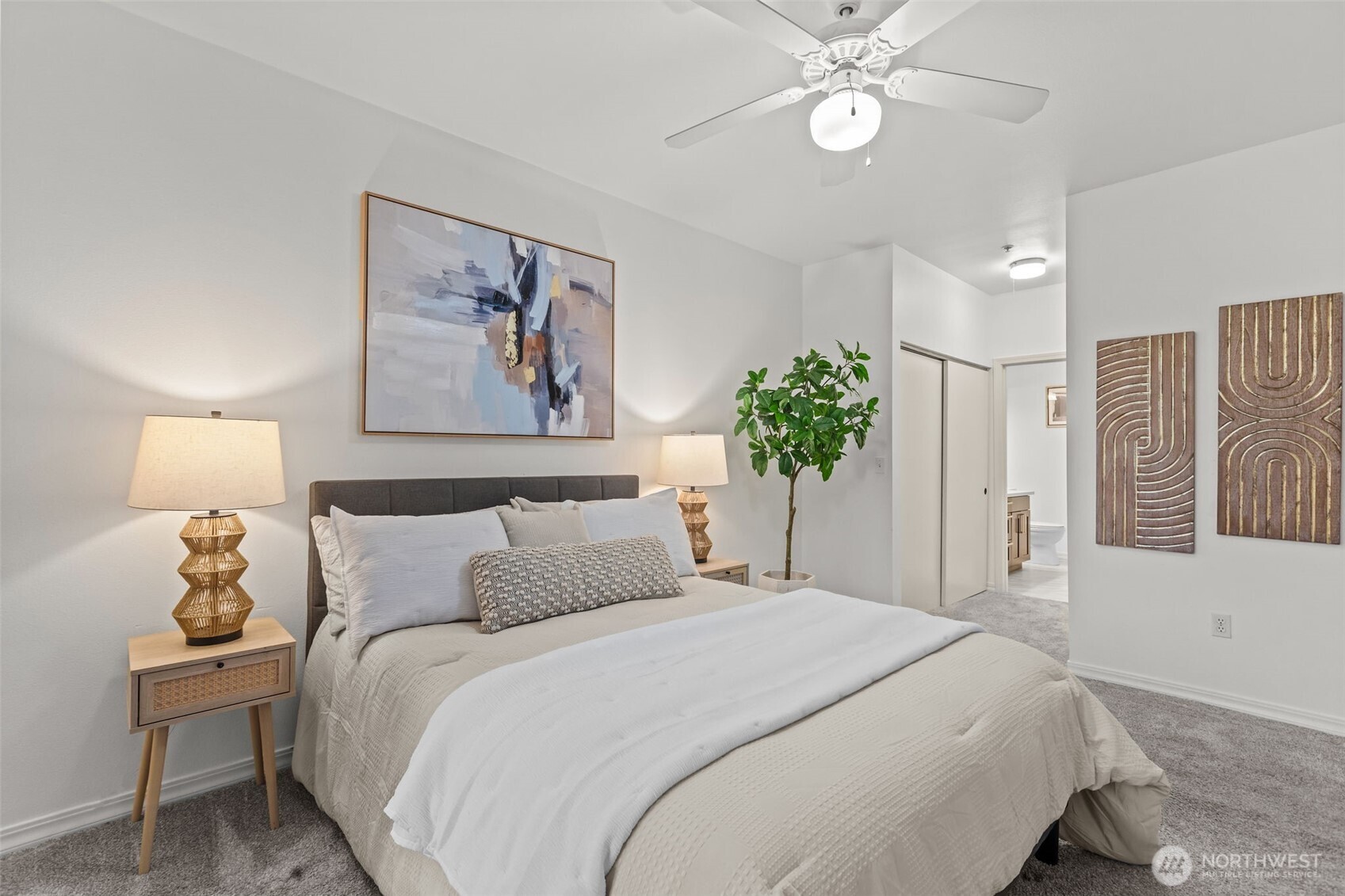 440 Maple Avenue Southwest, Unit A106 Renton, WA 98057 - Photo 20 of 39 a bedroom with a large bed and a chandelier